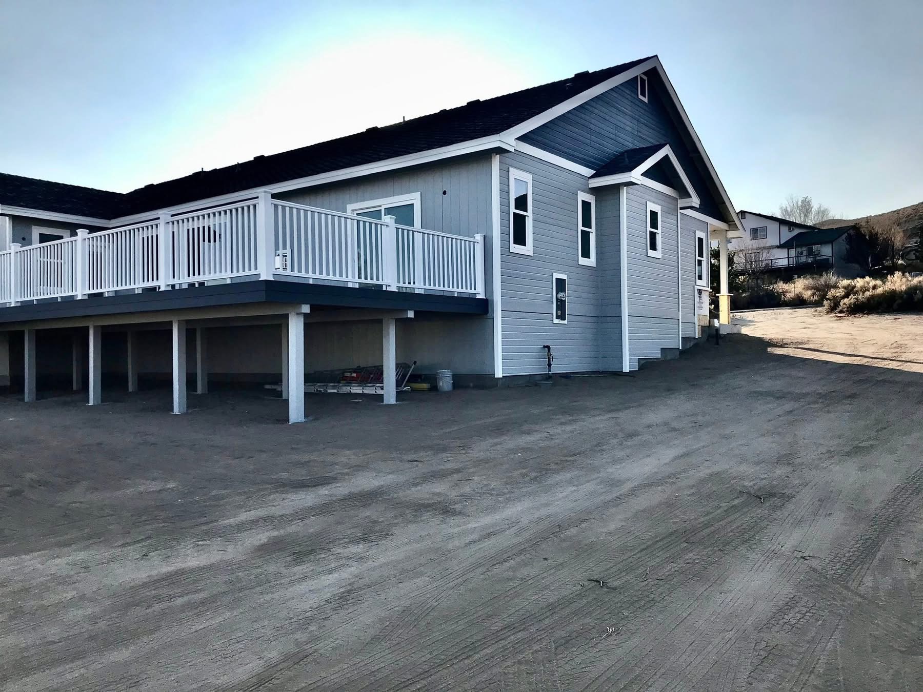 Gray home and deck finished by Silverland Innovation Coatings